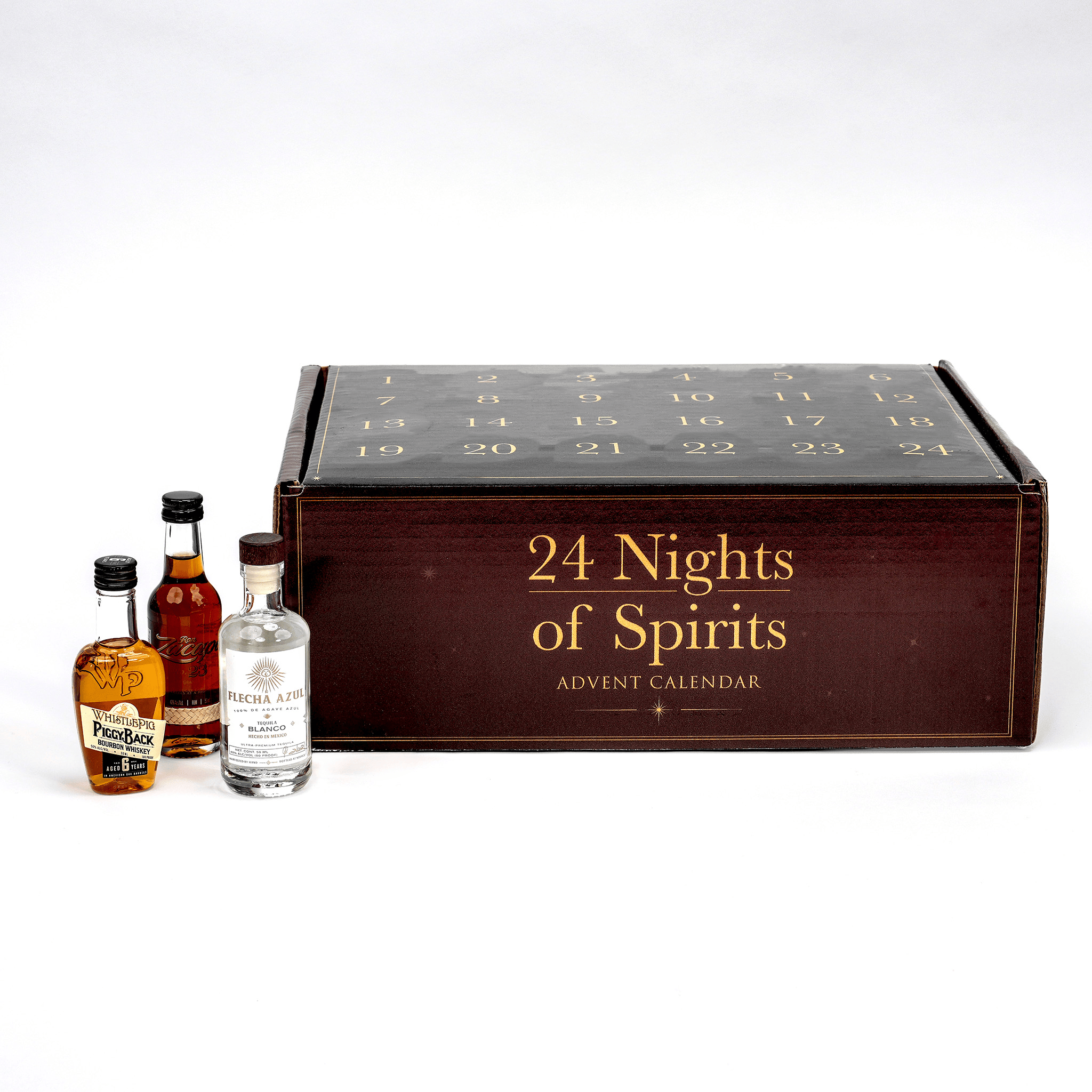 An advent calendarlabeled '24 Nights of Spirits Advent Calendar' in gold lettering on a dark wood-toned front, shown with three miniature spirit bottles in front on a clean white studio background.